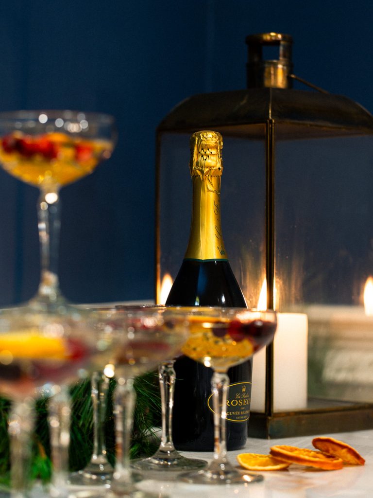 Close up photo of champagne bottle and glass on table