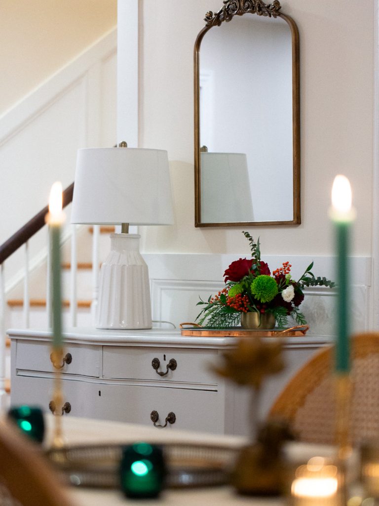 Close up of a table with a lamp and flowers