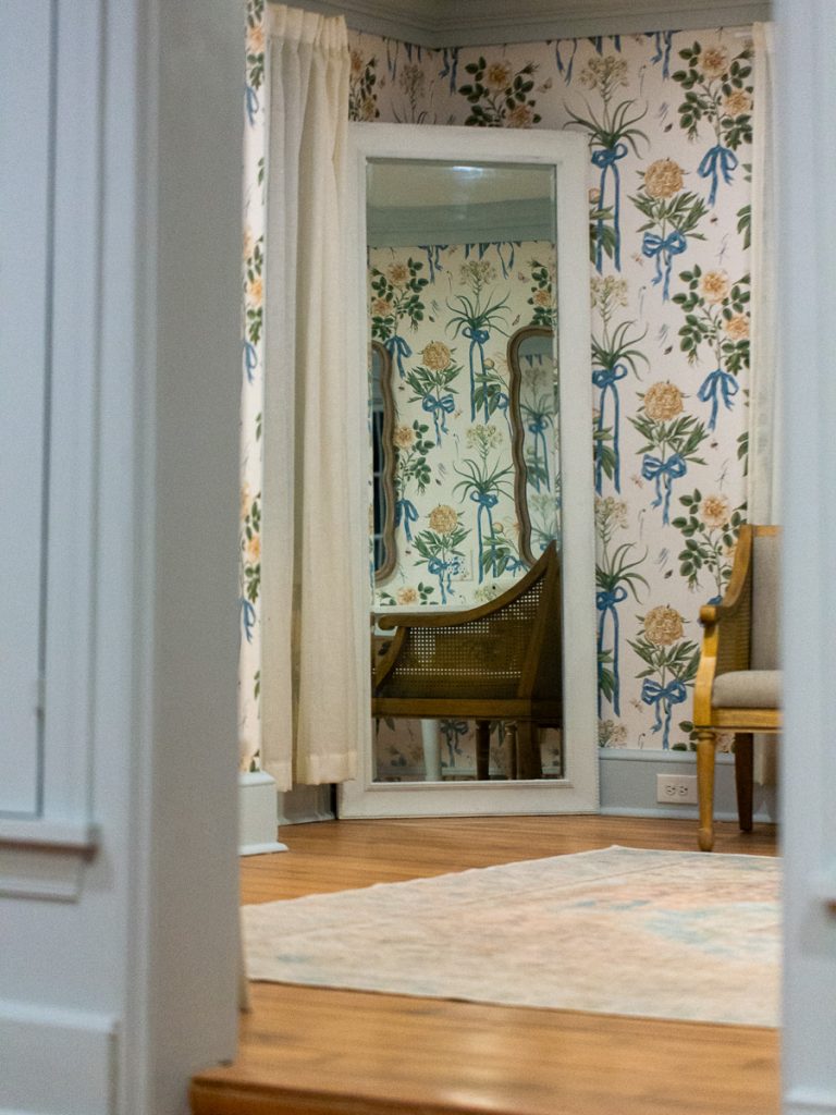 Medium compostion of a floor mirror photographed through a doorway