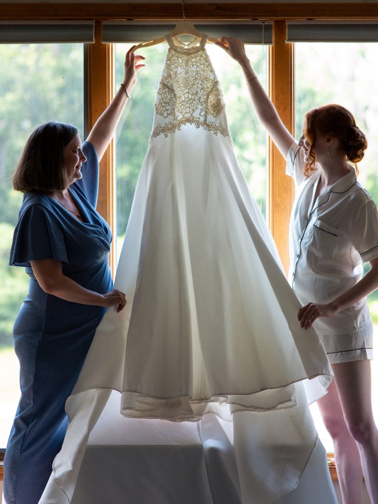bride and mom with wedding dress