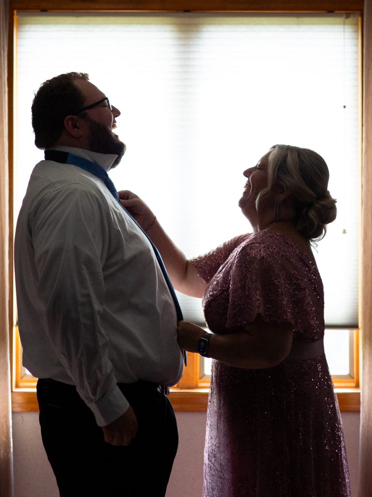 groom laughing with mom