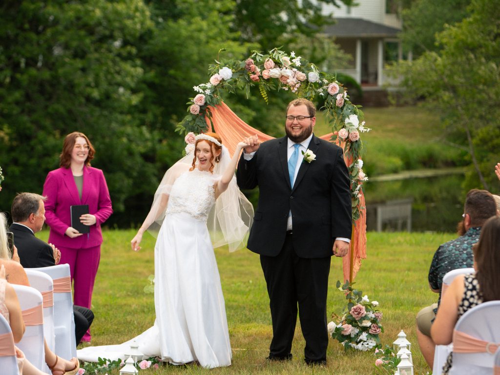 bride and groom holding hands and smiling