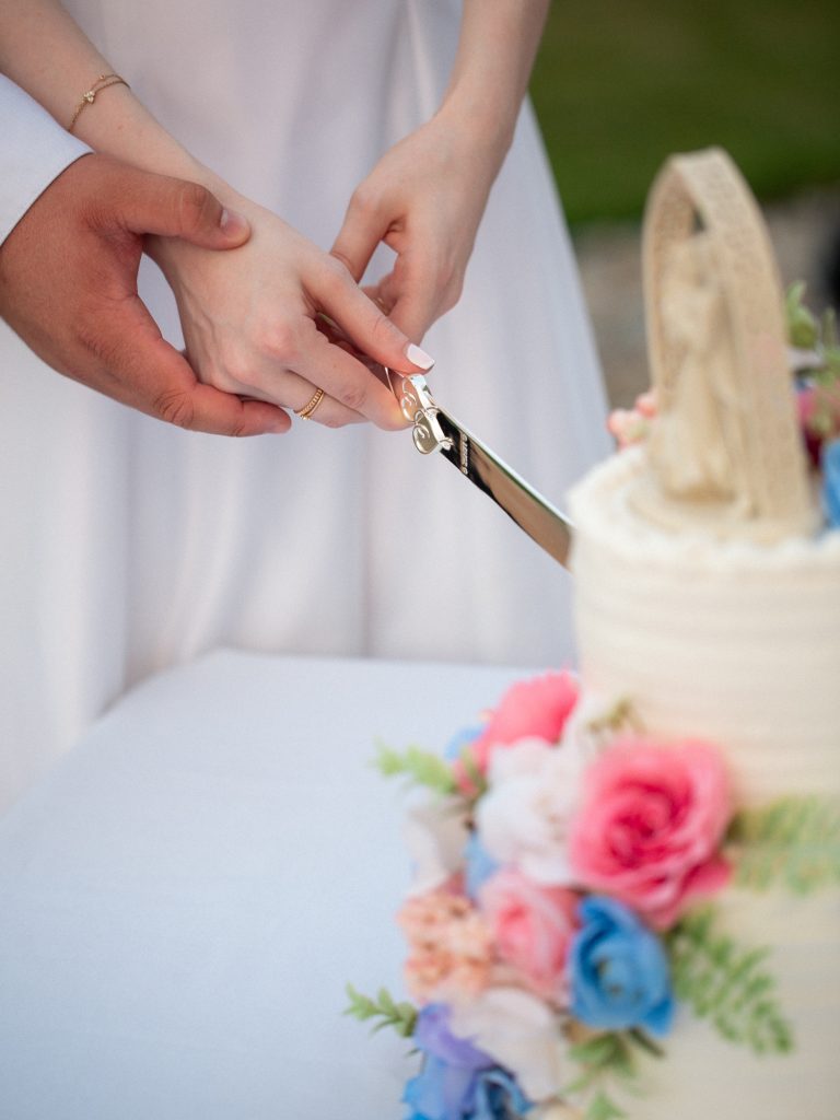 detail photo of bride and groom cutting cake